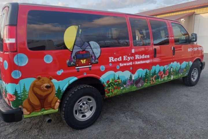 Red van with nature-themed mural, including a bear, tent, and flowers.